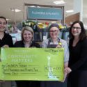 Waitrose employees present a cheque to Rachel (left) and Emma (right) of Children Today